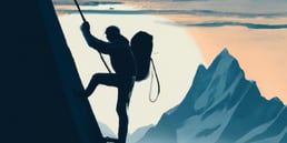 En klatrer som når toppen av et fjell