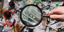 Looking at dollar bills through a magnifying glass